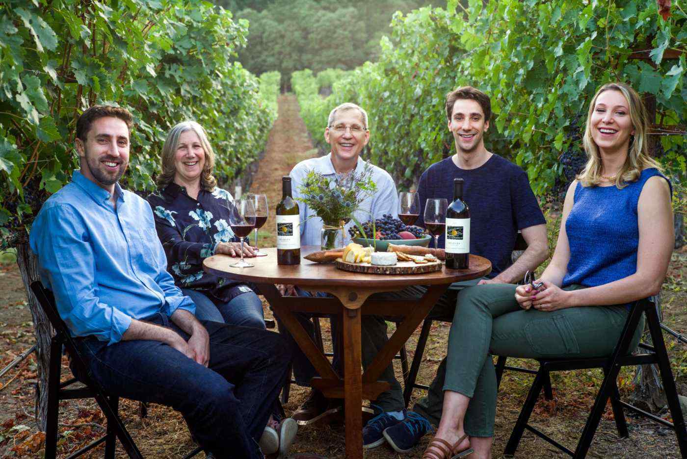 Heimark Family at a table in the vineyard
