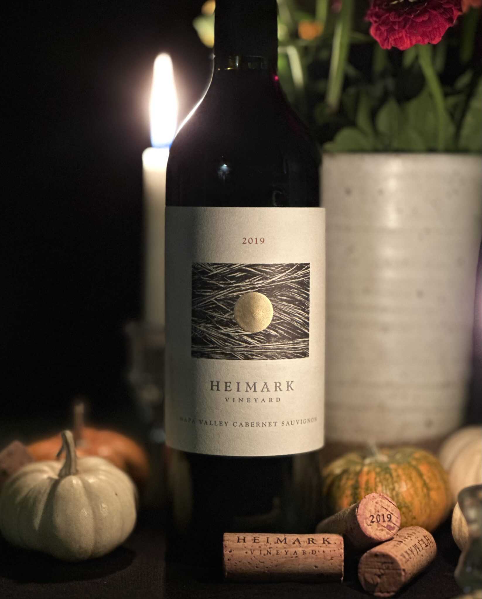 Heimark Vineyard Cabernet Sauvignon 2019 bottle on candlelit table with pumpkins and Heimark corks